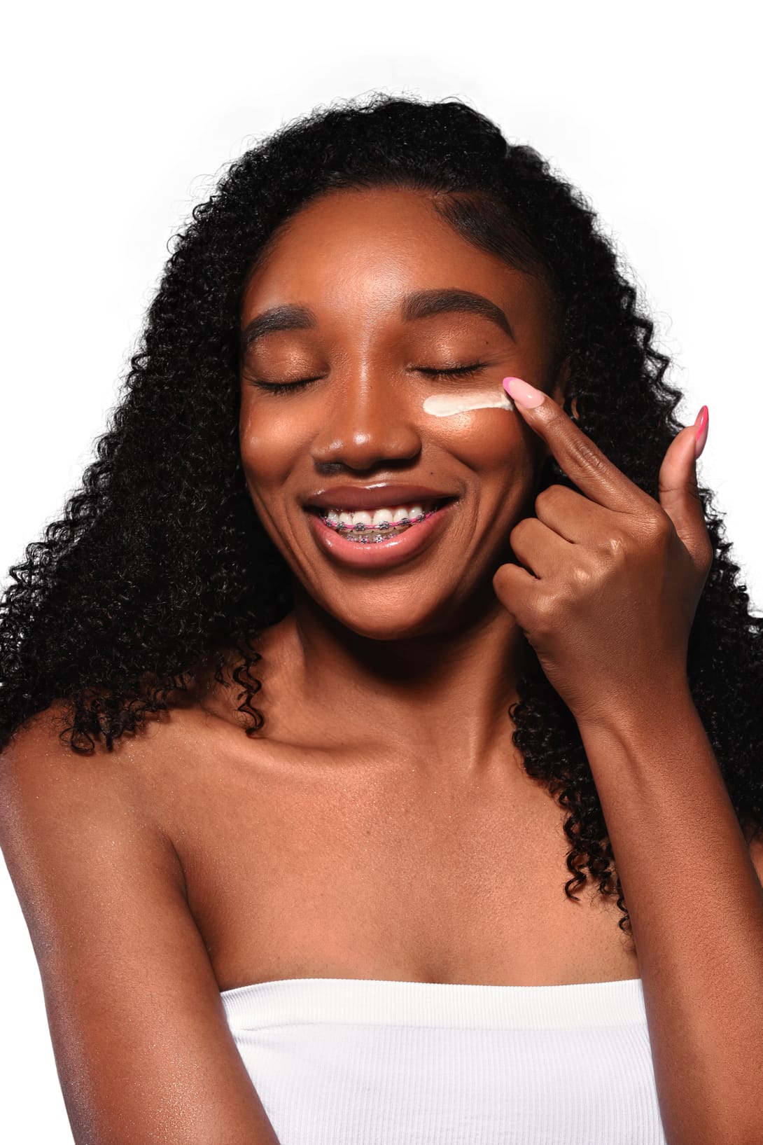 Woman applying crème to fade dark marks left by acne